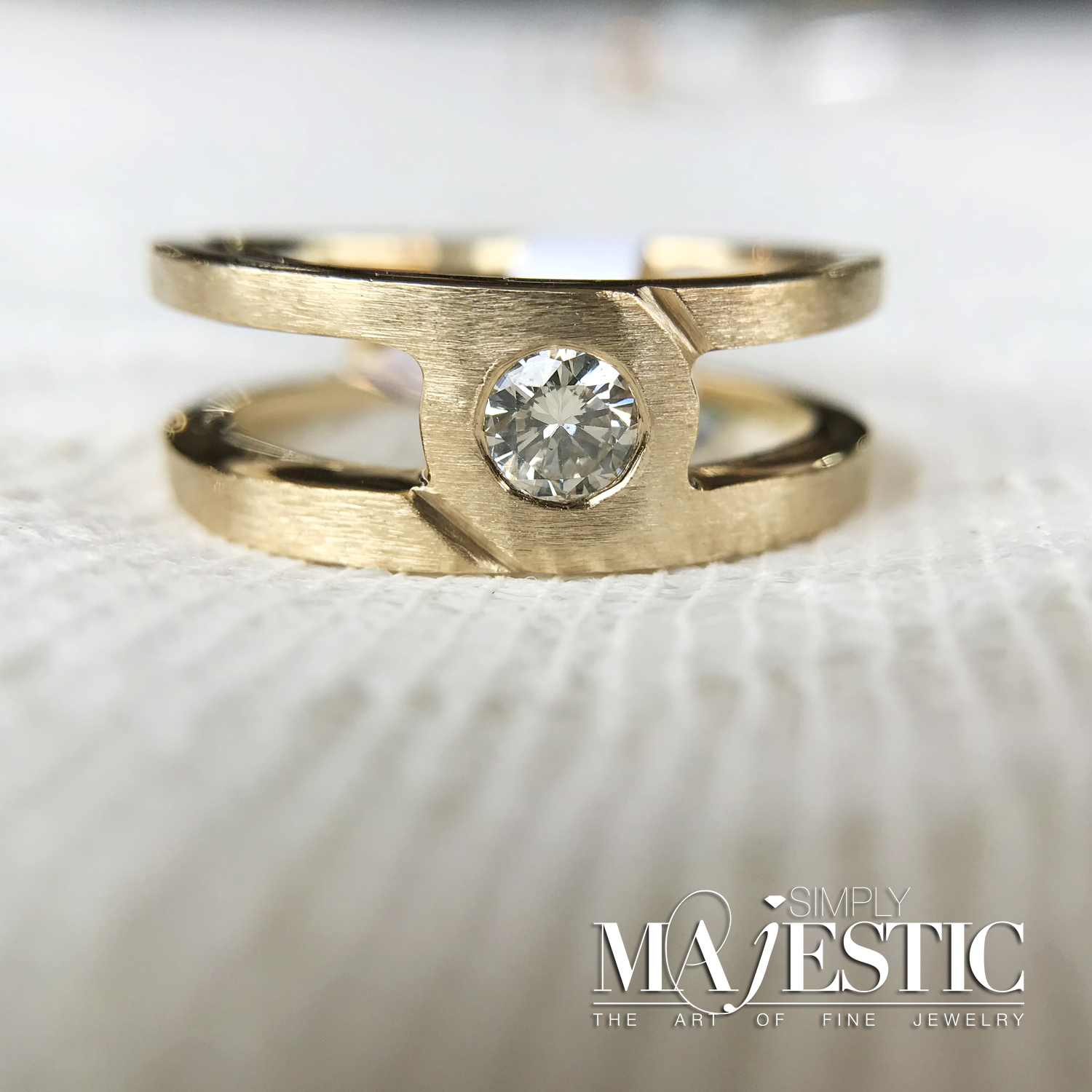 Image of a gold engagement ring on a gray background Ring shape and style guide from Simply Majestic jewelers